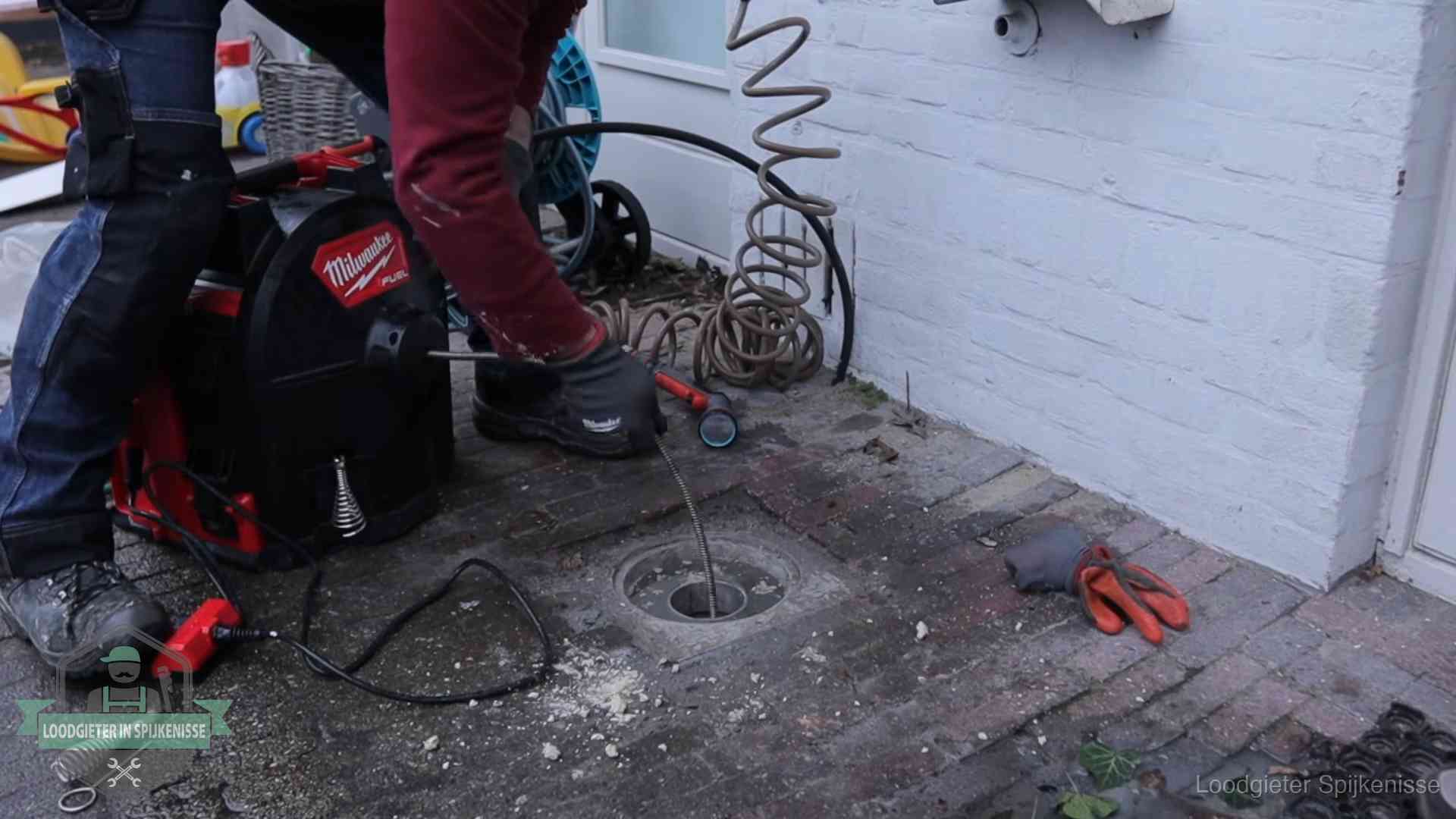 Spiraalmachine bij een ontstoppingsputje in de bestrating in Spijkenisse